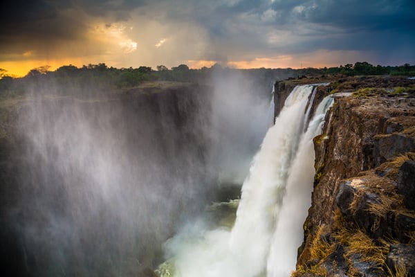 Zimbabwe Victoria Falls one of the 7 world wonders. Aerial view of water fall and African sunset.