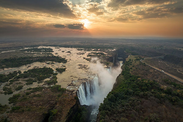 Zambia Victoria Falls. One of the 7 natural world wonders. Aerial view of sunset over waterfall ravine.