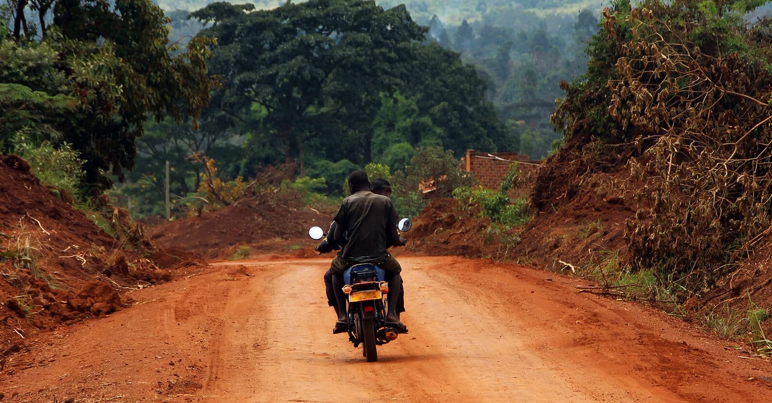 Boda bodas ride through the village streets of Uganda.