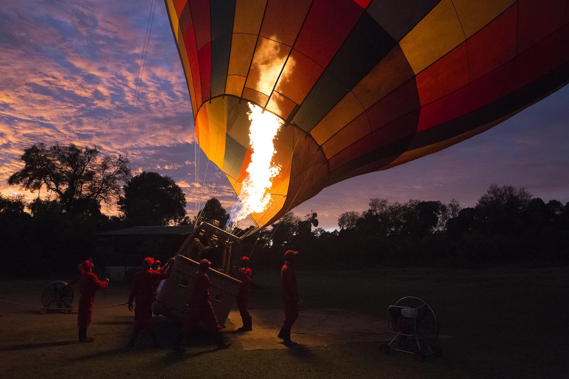 Igniting a hot air balloon at sunrise