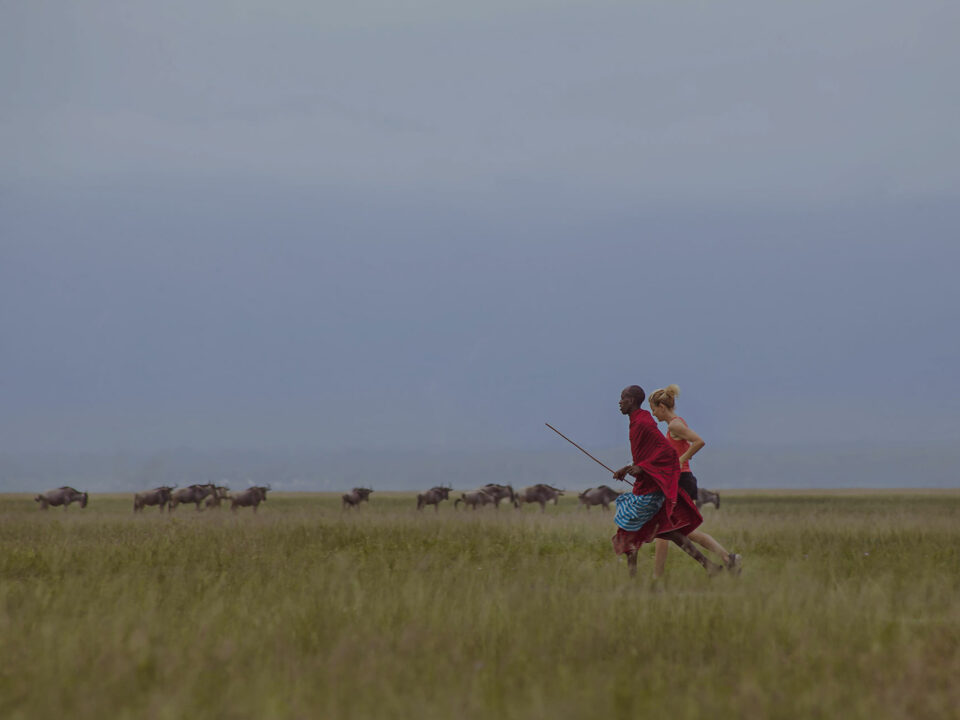 Maasai Man Jogging with Tourist Wide View which could be on your bucket list travel