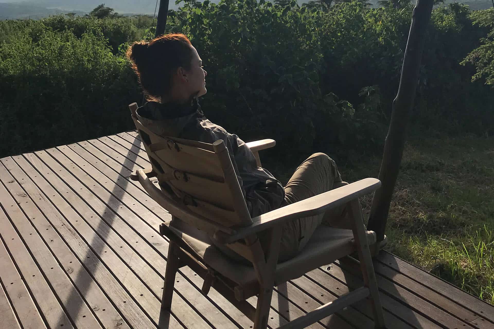 Luana sitting in a chair at her tented suite at Entamanu Ngorongoro