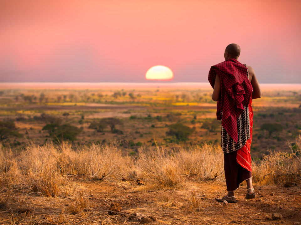 Sun setting while a maasai of East Africa is walking