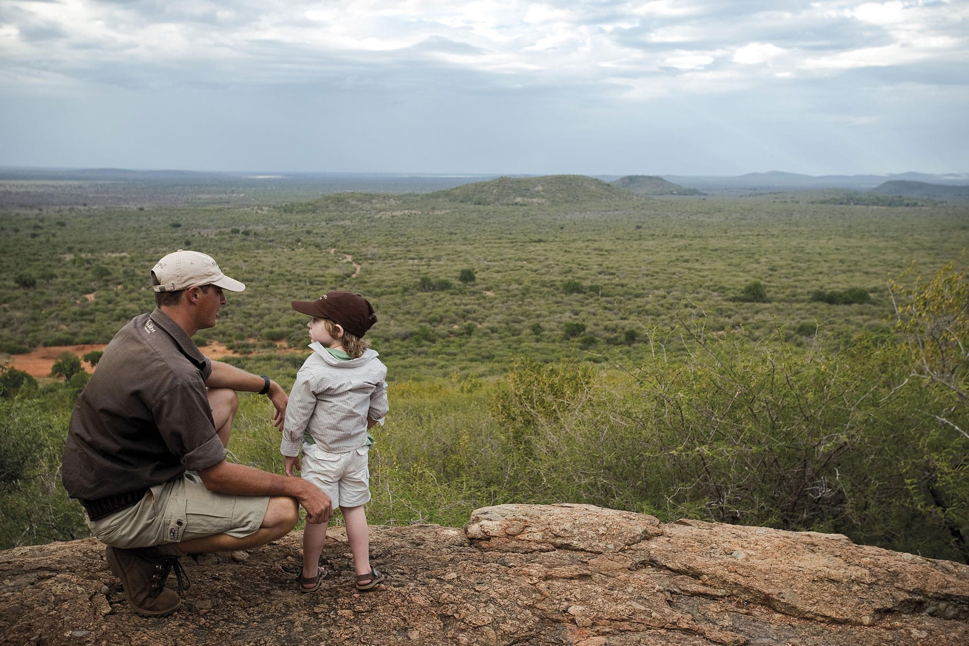A ranger teaches a young guest during a malaria-free safari in south africa