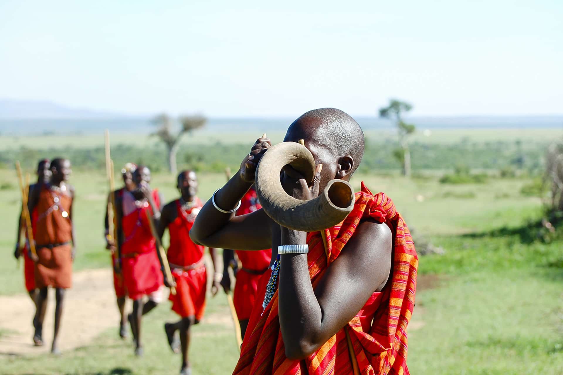 A Maasai warrior of East Africa blowing a Kudu horn