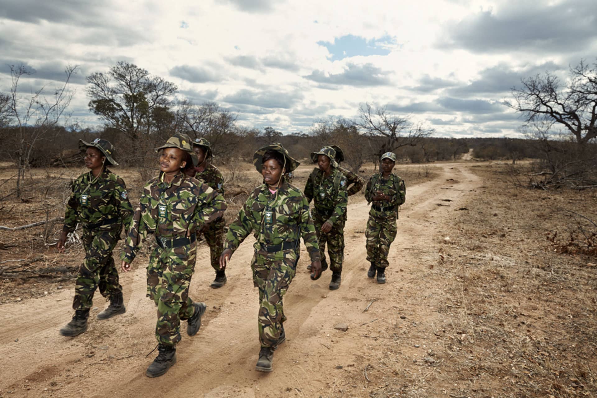Women walking in military uniform in the bush. Conservation in South Africa