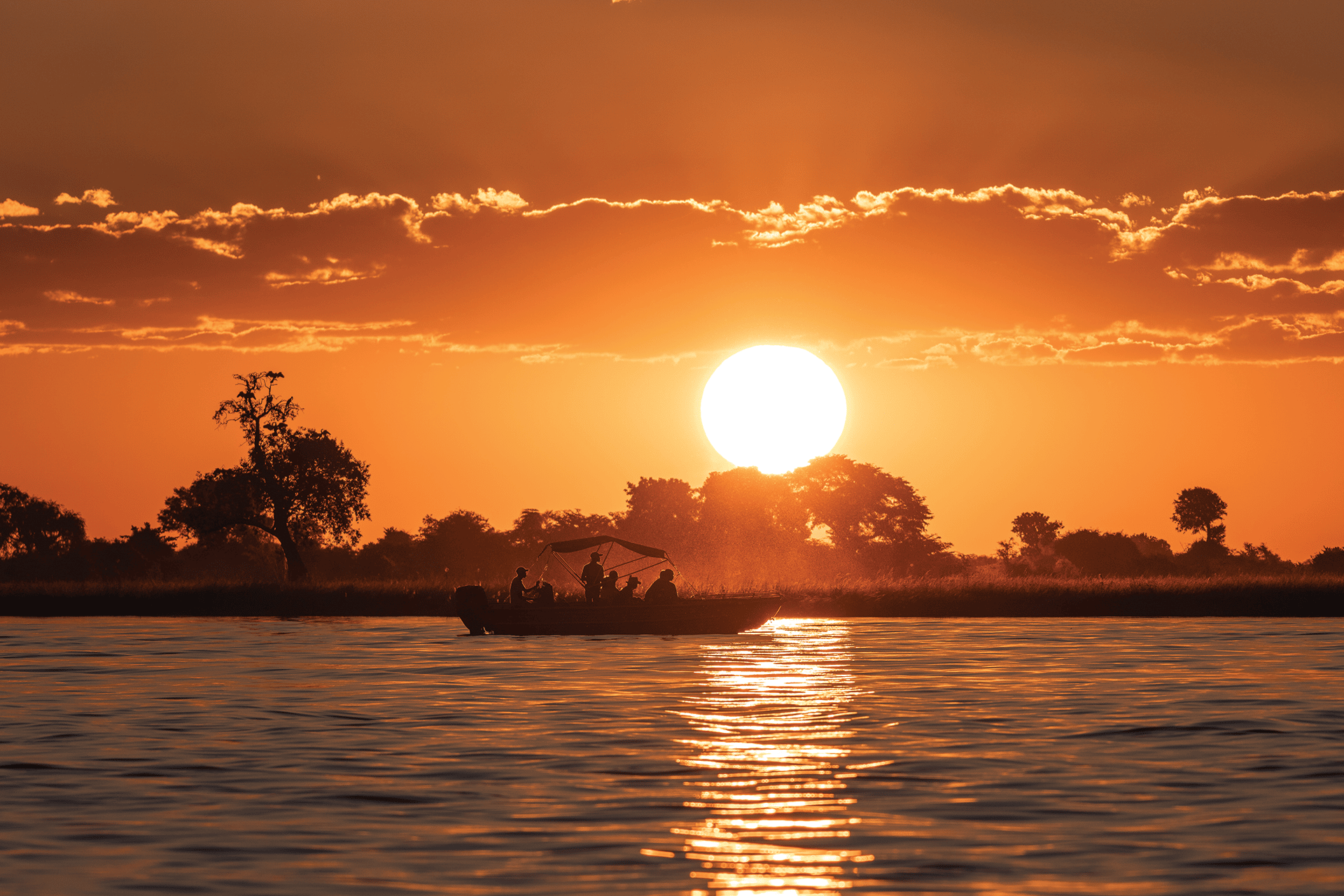 Guests enjoying a sunset Zambezi river cruise at Victoria Falls