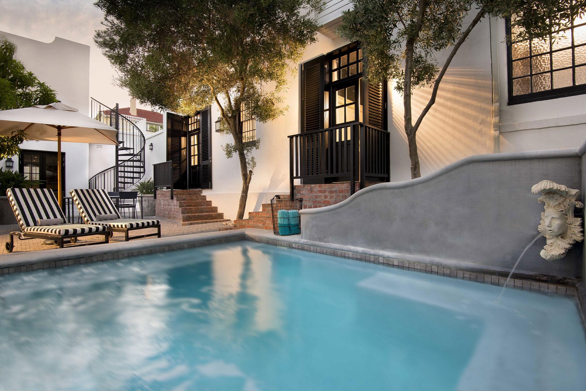 2 sun loungers next to the hotel plunge pool at the Cape Cadogan Boutique Hotel.