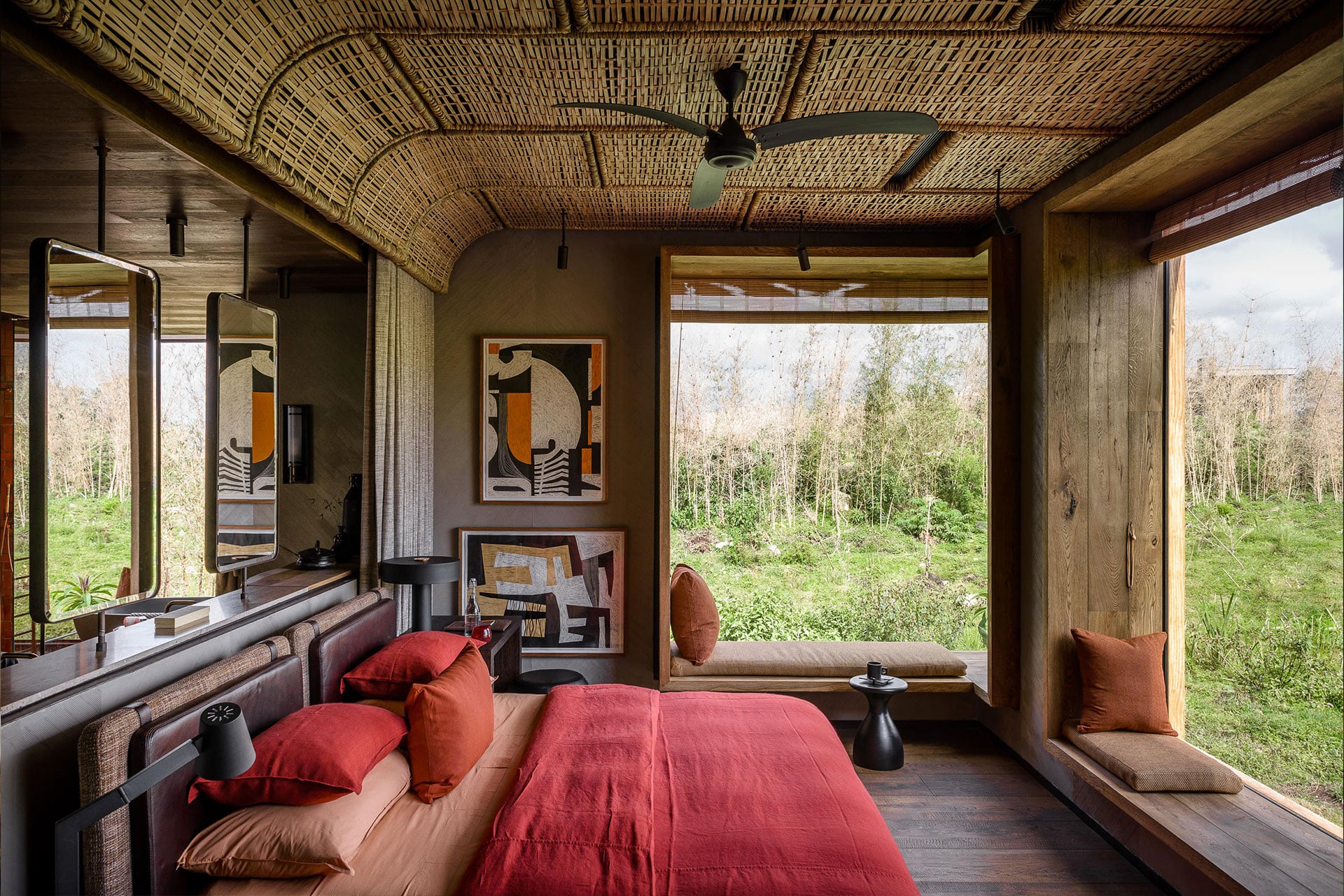A bedroom with large windows at luxury lodge Singita Kwitonda Lodge