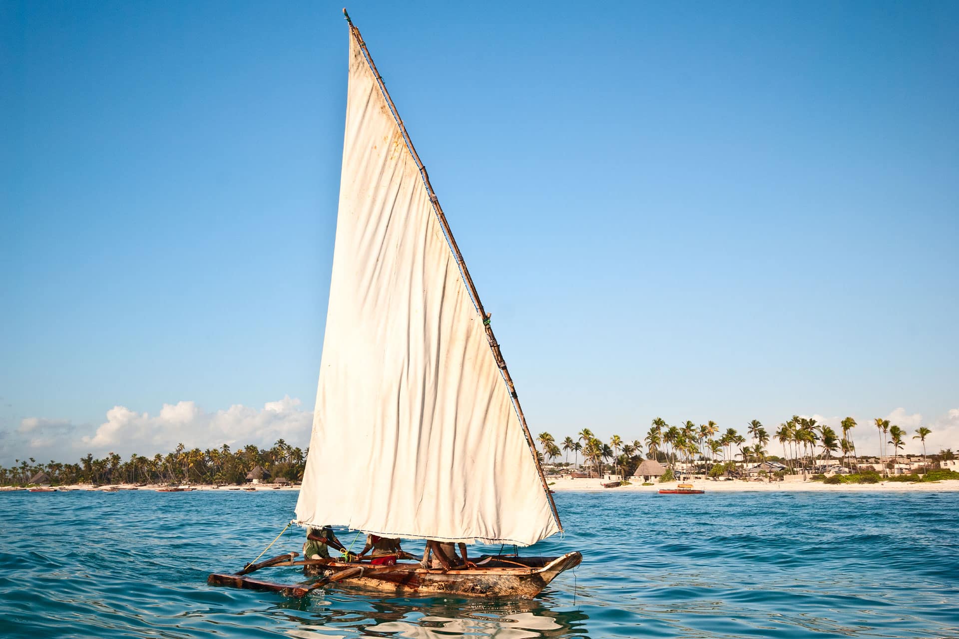 A dhow boat sailing on the waters in Zanzibar in East Africa