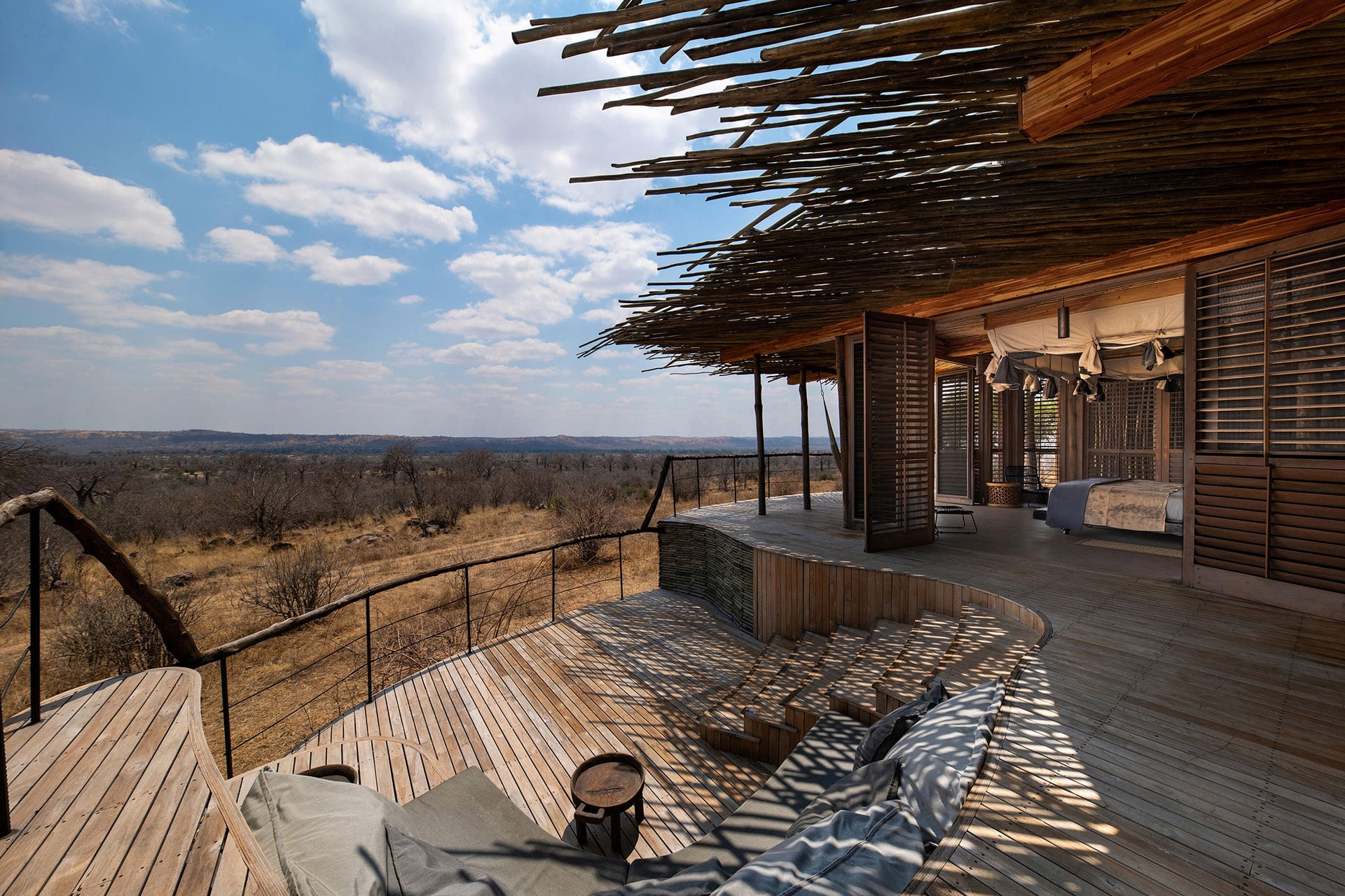 A wooden bedroom suite with private deck at Jabali Ridge in Ruaha National Park, Tanzania.