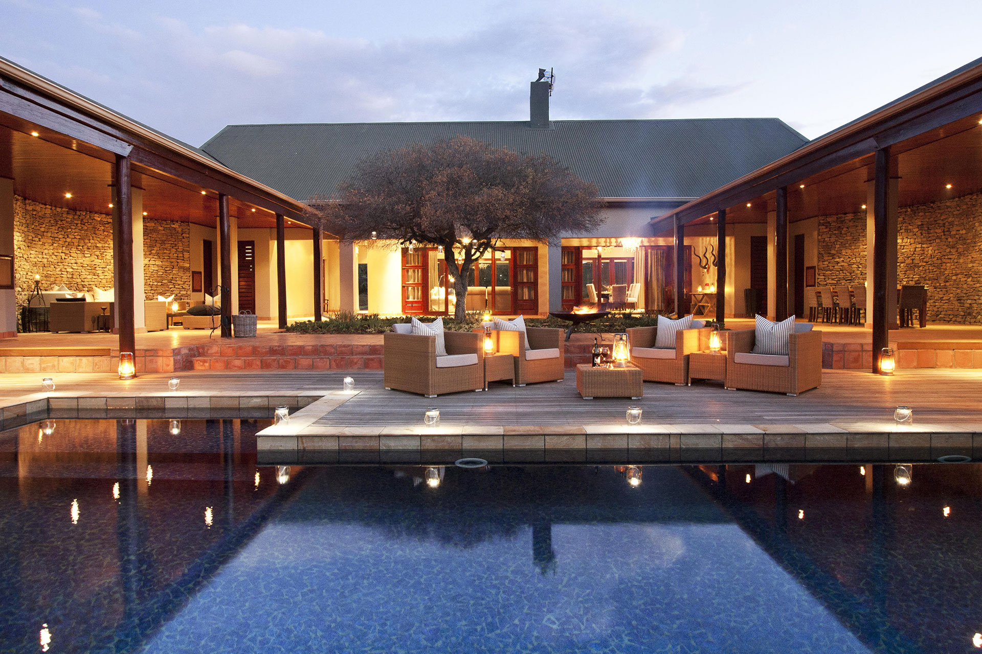 Outdoor seating and the pool at Melton Manor at Kwandwe Private Game Reserve.