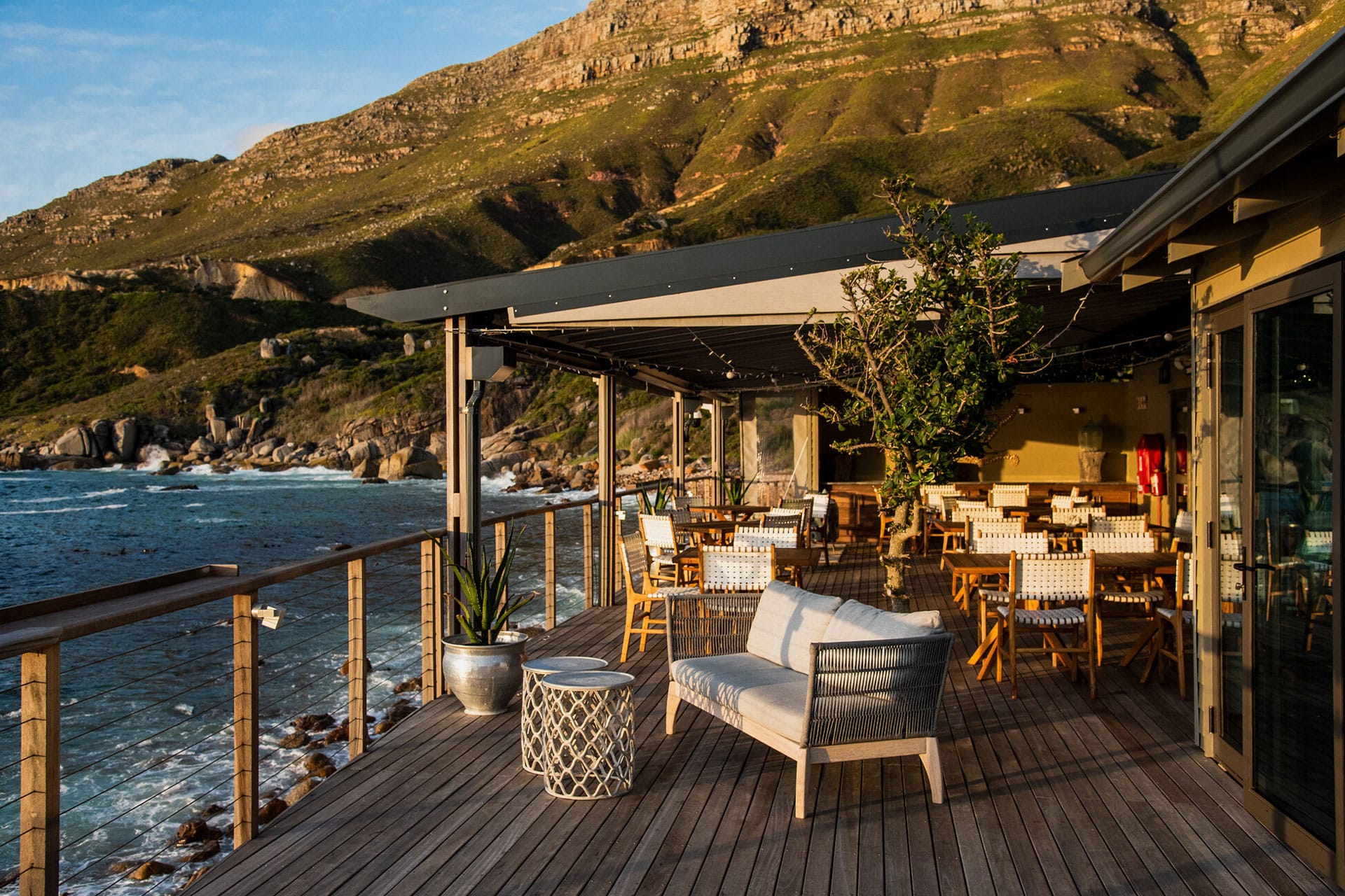 The al fresco dining area with views of the Table Mountain National Park and Atlantic Ocean at Chefs Warehouse Tintswalo Atlantic – one of the top 10 fine dining restaurants in Cape Town.