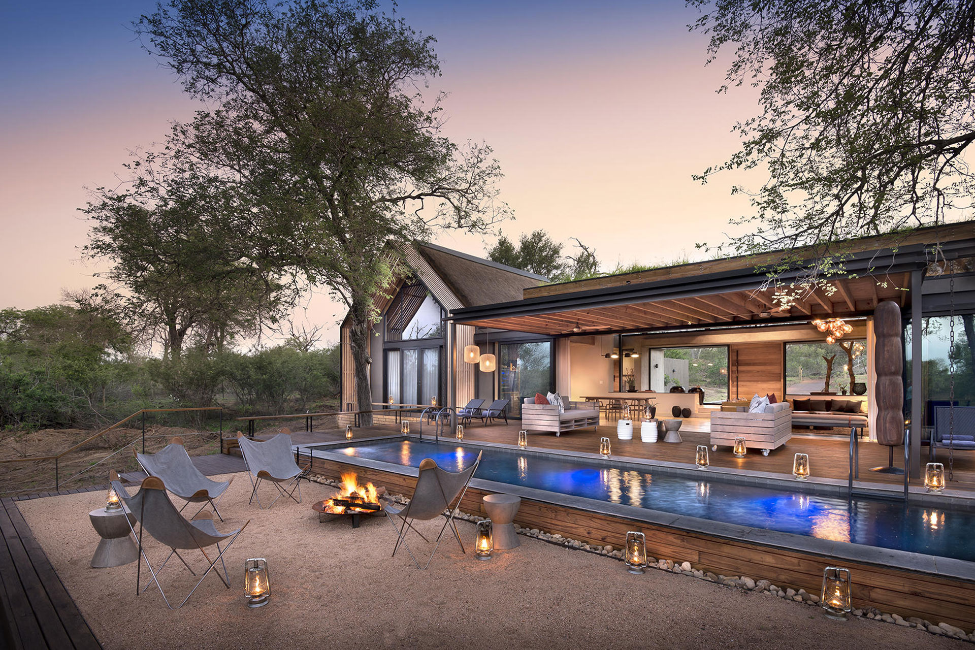 The open plan lounge area, outdoor pool and fire pit at Fish Eagle Villa in the Lion Sands Game Reserve