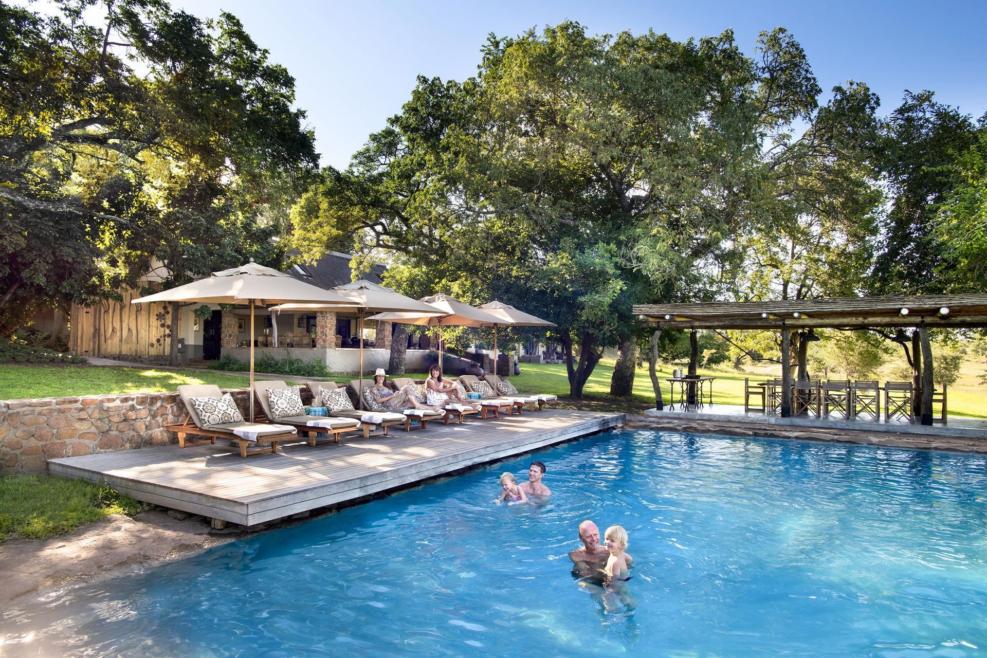 A swimming pool and sun loungers at Singita Sabi Sands Castleton Lodge.