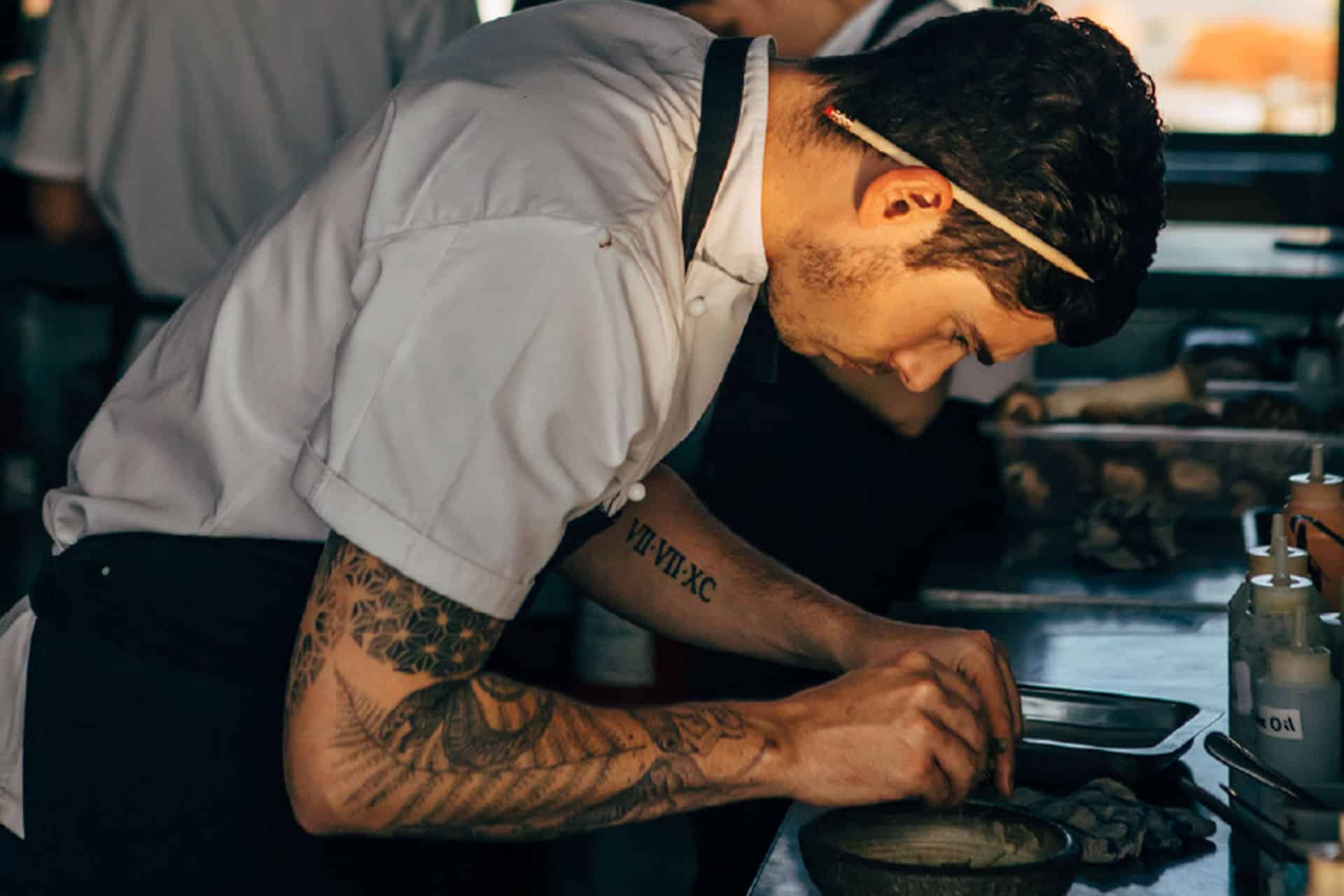 A chef plating food at The Pot Luck Club – one of the top 10 fine dining restaurants in Cape Town.