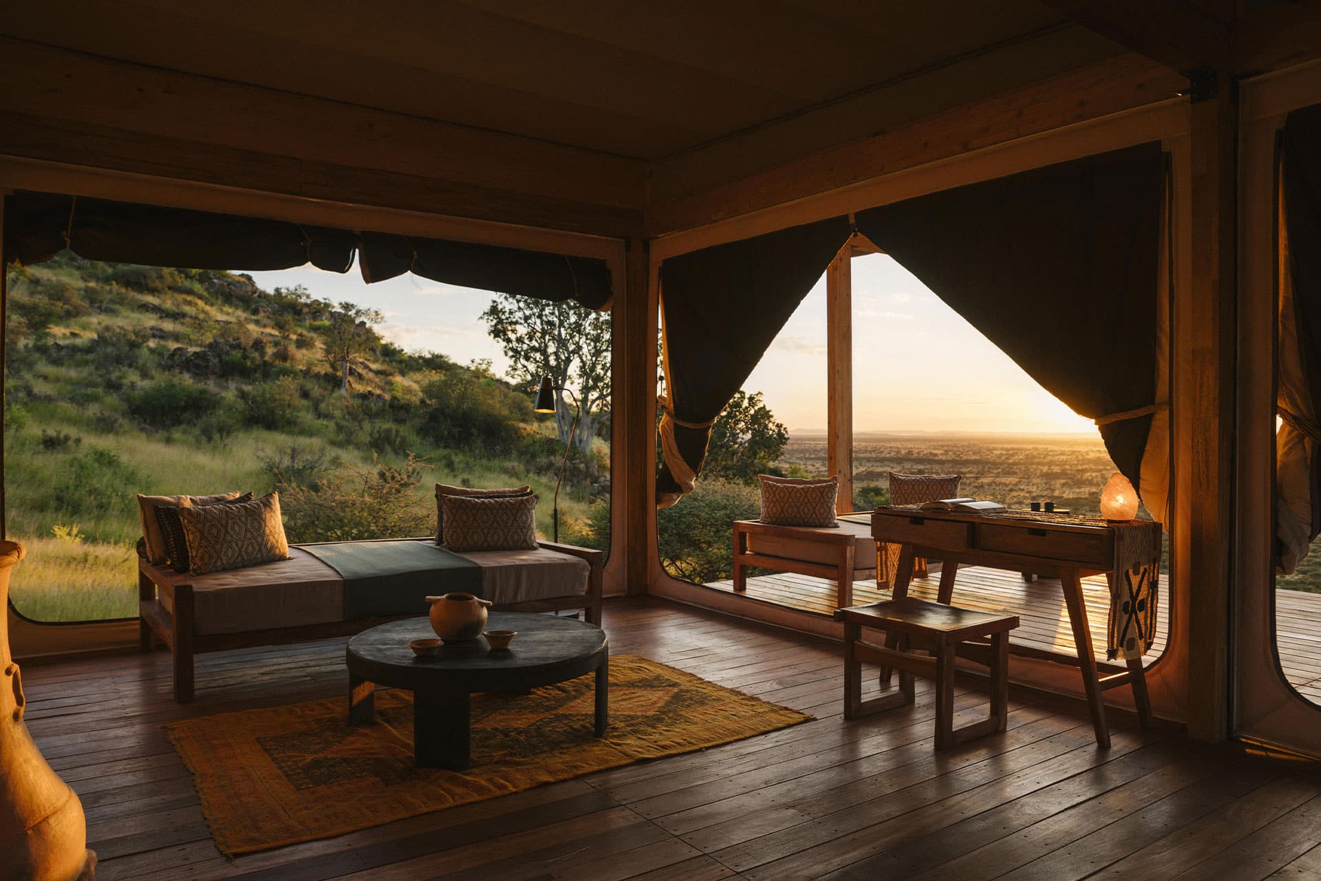 Seating area at Habitas Namibia with views of the savannah plains.
