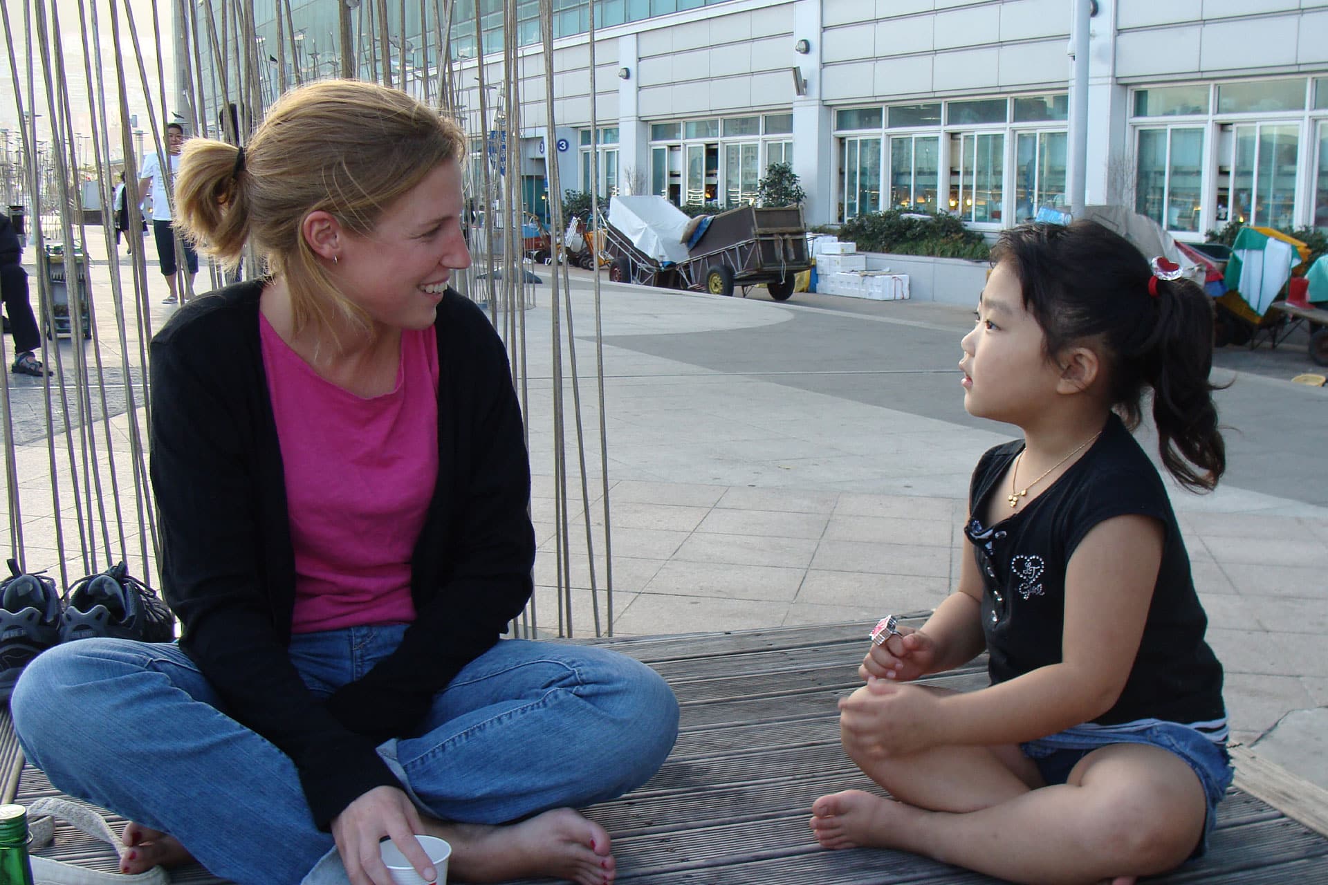 Holly Tuppen speaking to a young Korean girl in South Korea.