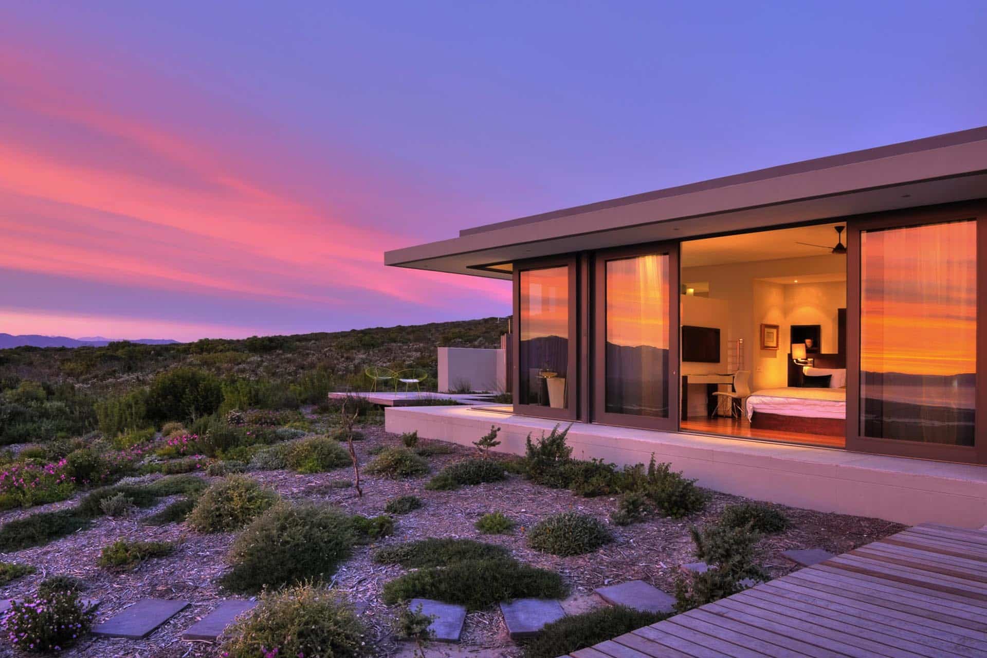 A private villa on the fynbos reserve during sunset at Grootbos Private Nature Reserve – one of the top Eco Lodges in Africa.