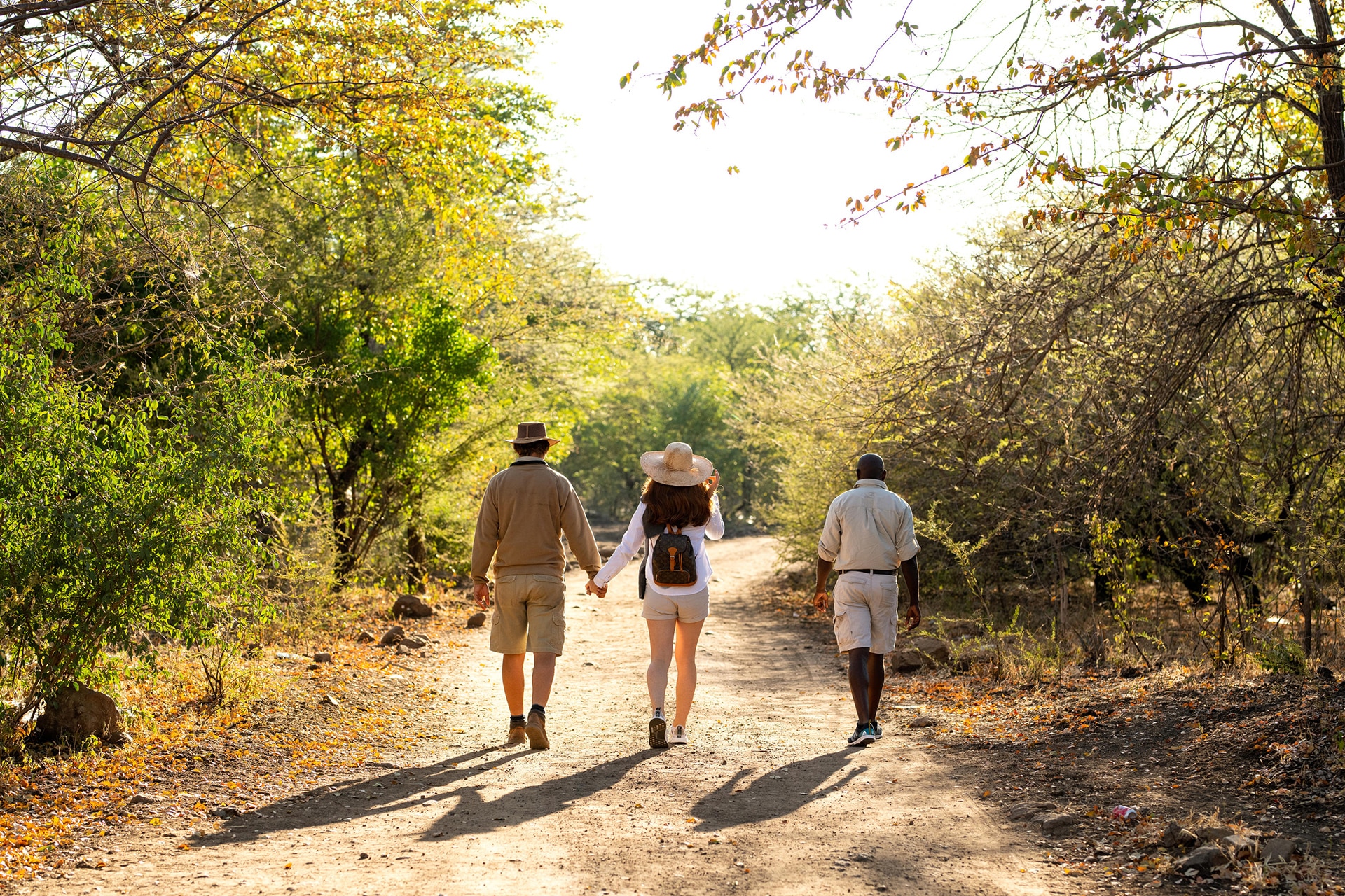 A couple walking on Impalila Island to see the quadripoint – a recommended experience for honeymoons in Africa.