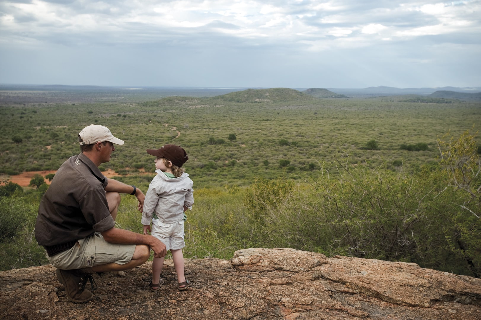A ranger and a child looking out into the bush at Madikwe Hills Private Game Lodge – one of Southern Africa’s best family friendly lodges.