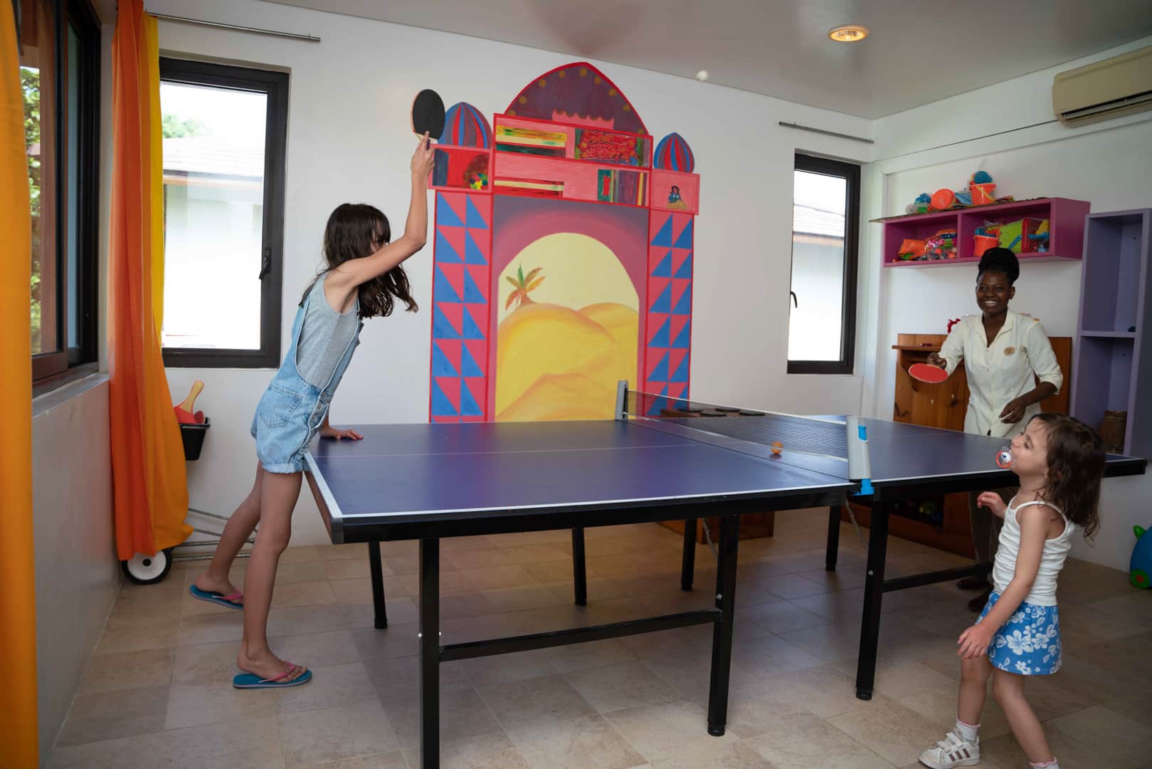 Kids enjoying a game of ping-pong at the Residence Zanzibar’s Kids Club – one of the top rated Zanzibar resorts with Kids Clubs.