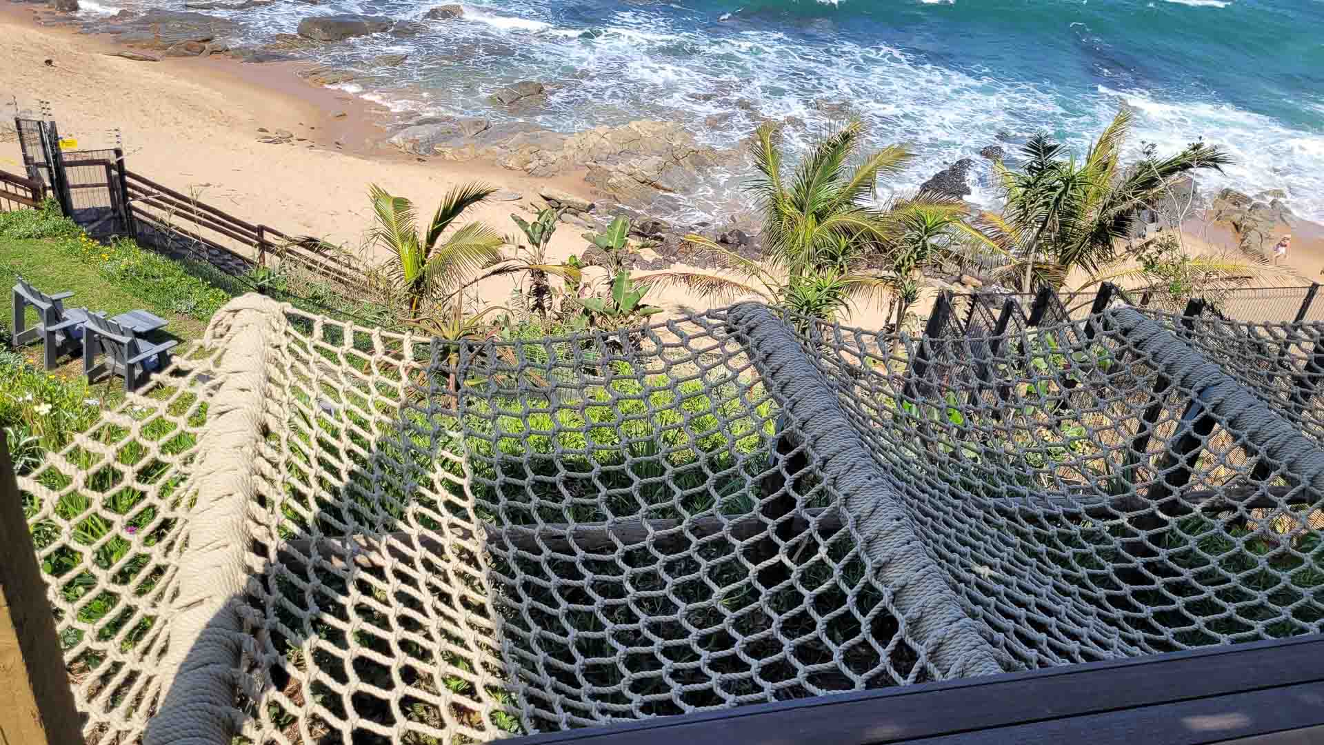 A rope hammock with a view of the ocean at Sala Beach House – a popular Ballito hotel.