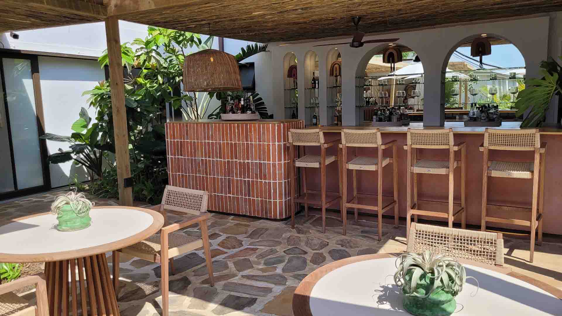 An outdoor bar and tables and chairs at Sala Beach House - one of the top Ballito hotels.