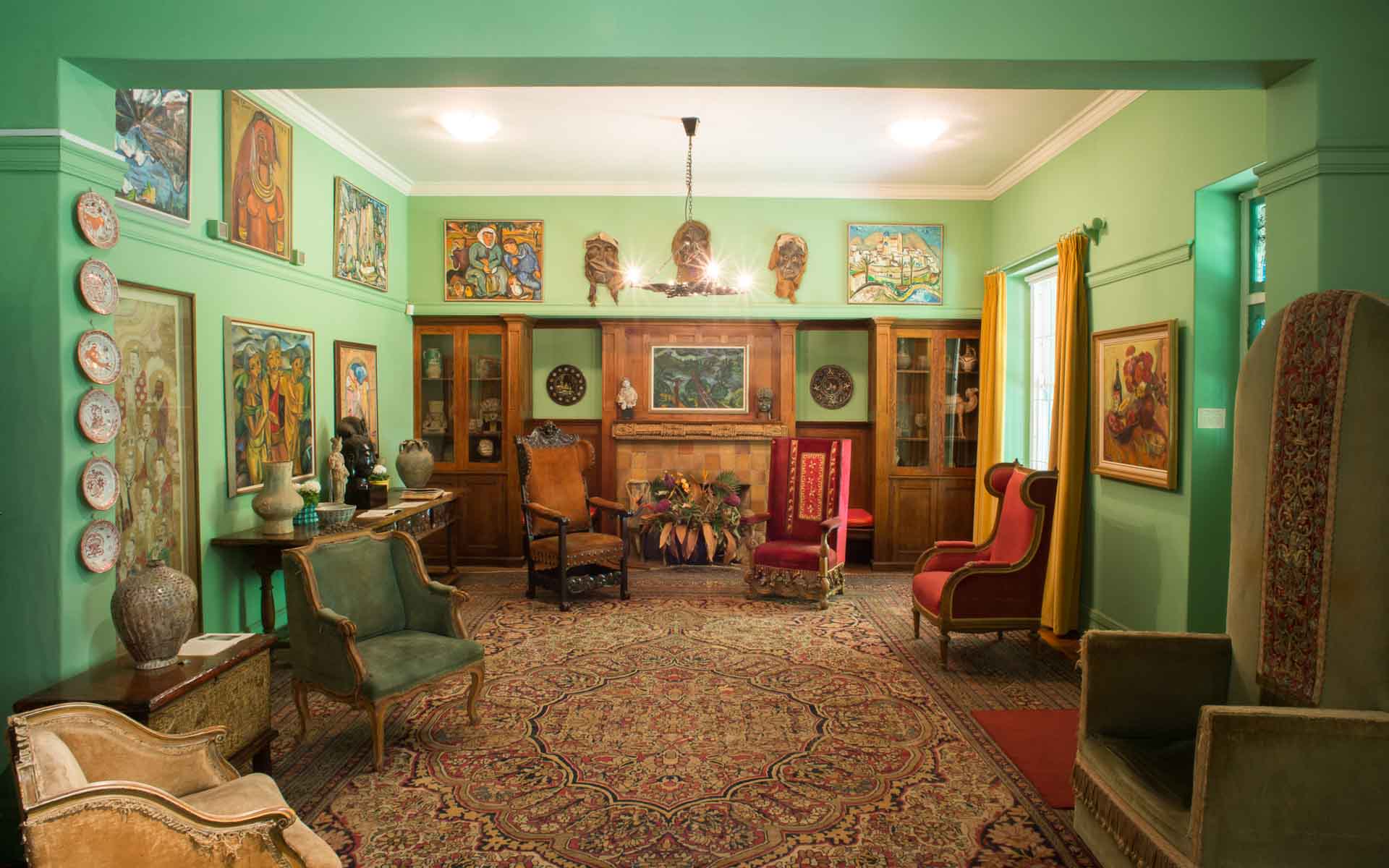 Artworks and eccentric furnishings in the lounge of the late artist, Irma Stern – a glimpse into one of the top art galleries in Cape Town.