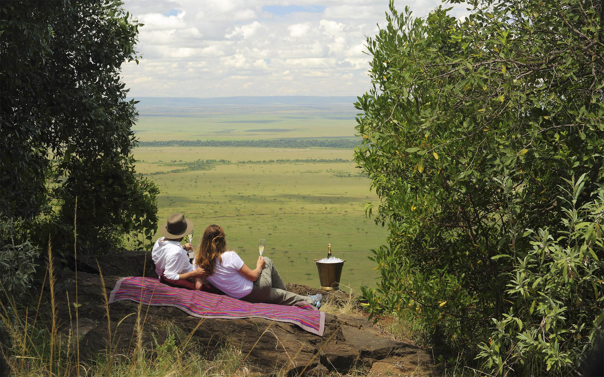A romantic picnic on the crest of the ‘Out of Africa’ kopje at Angama Mara, part of Ker & Downey Africa’s best Africa safaris of 2022.