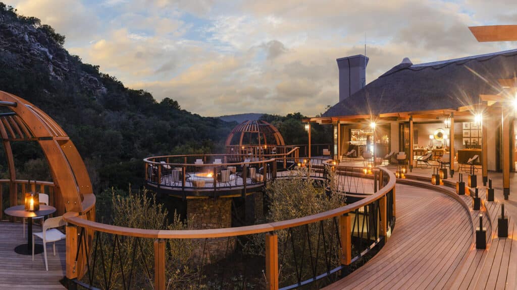 Large wooden deck with lights at dusk at Eagles Crag with Ker & Downey Africa