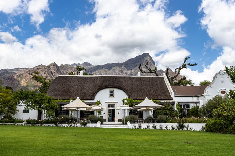 Manor House with lawns in front of mountain with Ker & Downey® Africa