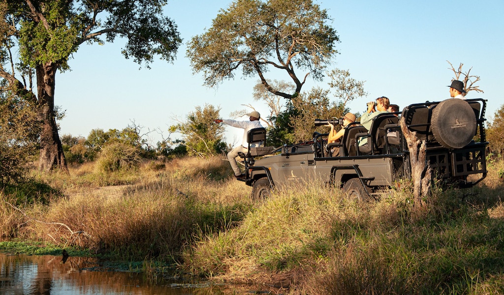 Electric safari vehicle at Cheetah Plains with a tracker on private safari in South Africa with Ker & Downey Africa