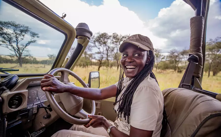 Female guide at Dunia in Safari vehicle