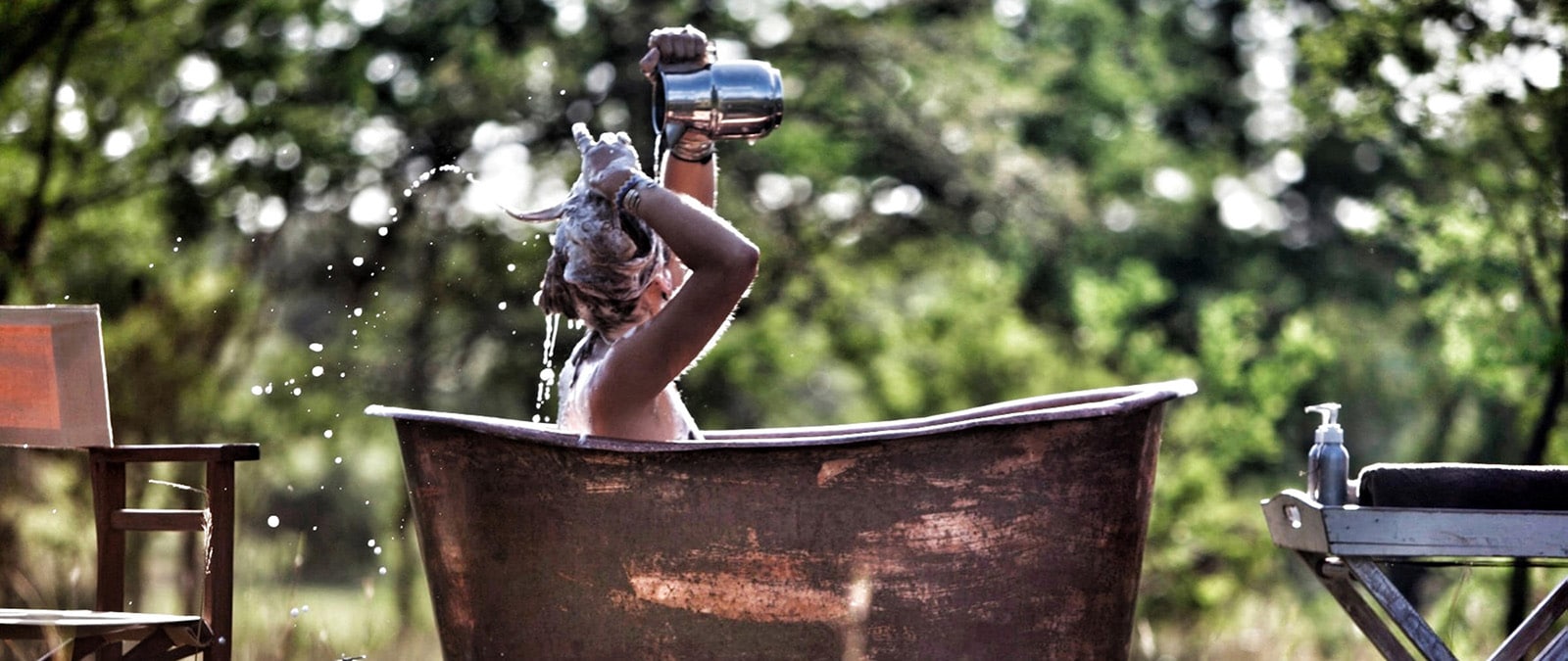 Woman in copper bath at Serian Serengeti