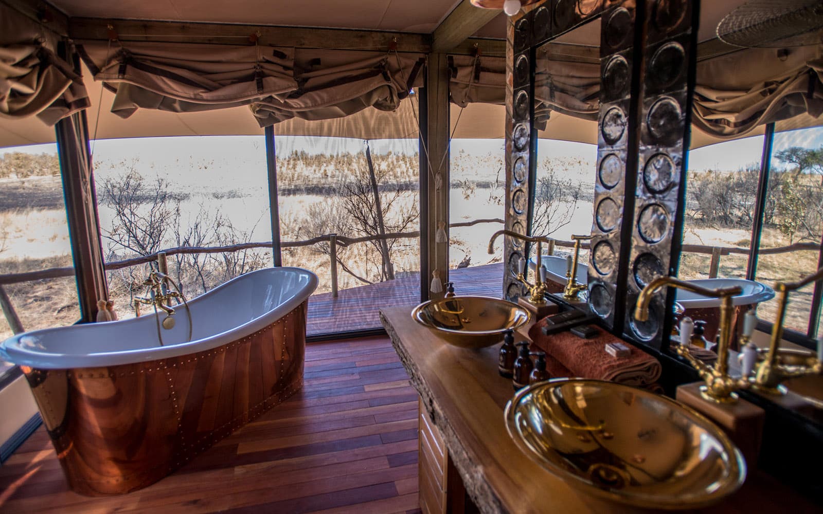 Bathroom with double vanities and mirrors at Somalisa Camp with Ker & Downey Africa
