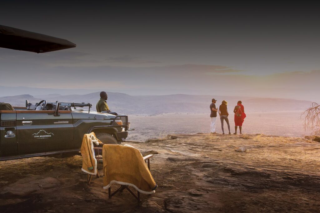 Safari vehicle traversing golden Masai Mara plains at sunset, Kenya. Discover three pioneering wildlife conservation areas on this environmentally friendly 10 day Electric Vehicle Safari in Kenya.