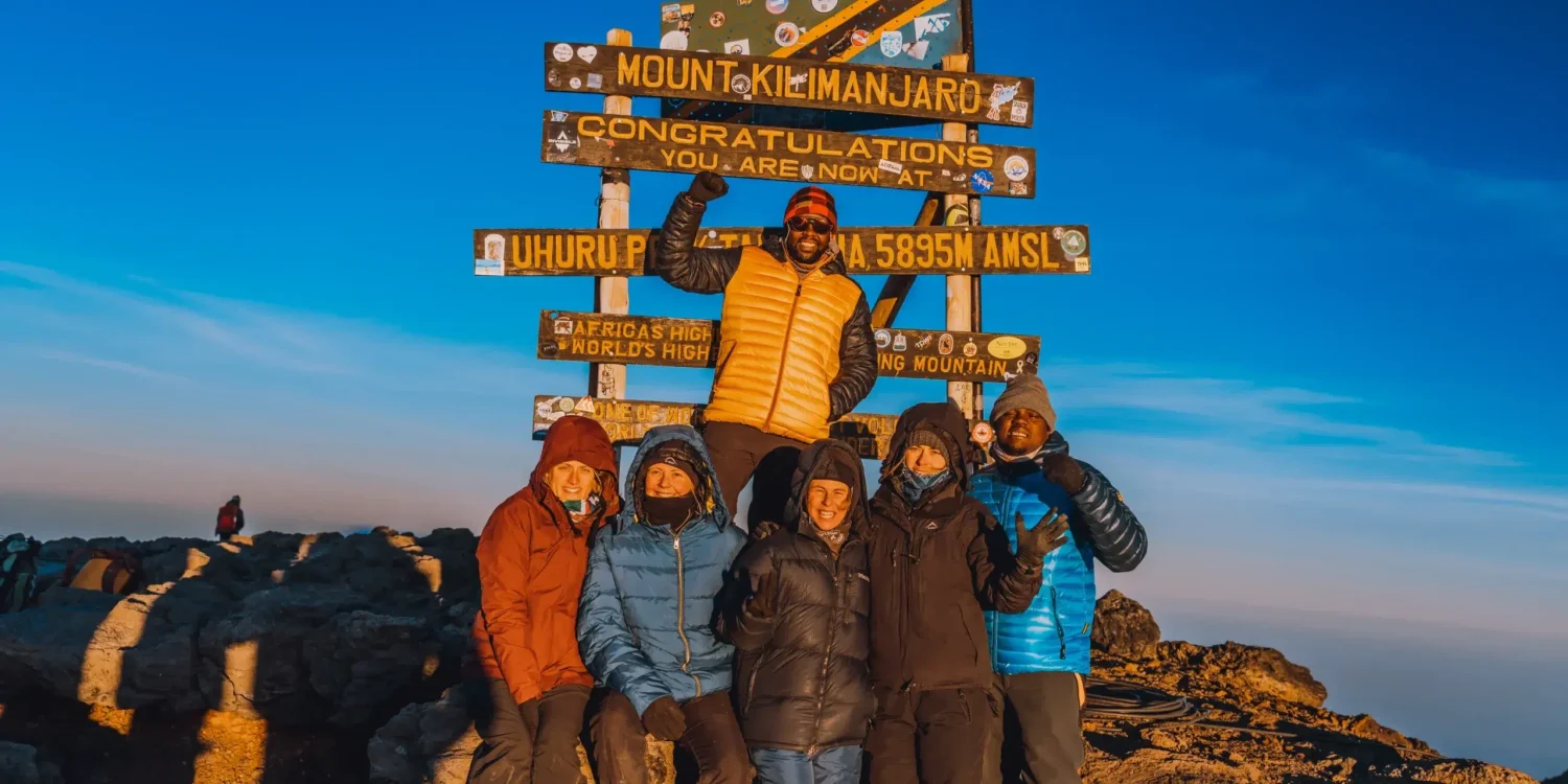 The team from Ker & Downey Africa standing at the top of Mount Kilimanjaro