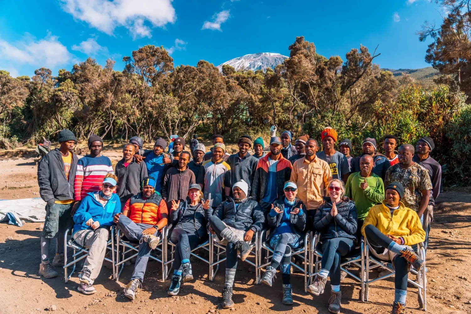 The team from Ker & Downey Africa with the porters and guides and Mount Kilimanjaro in the background