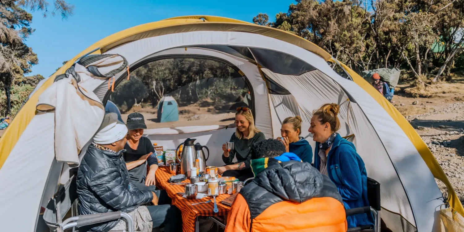 The team from Ker & Downey Africa enjoying a meal together in a tent on Mount Kilimanjaro