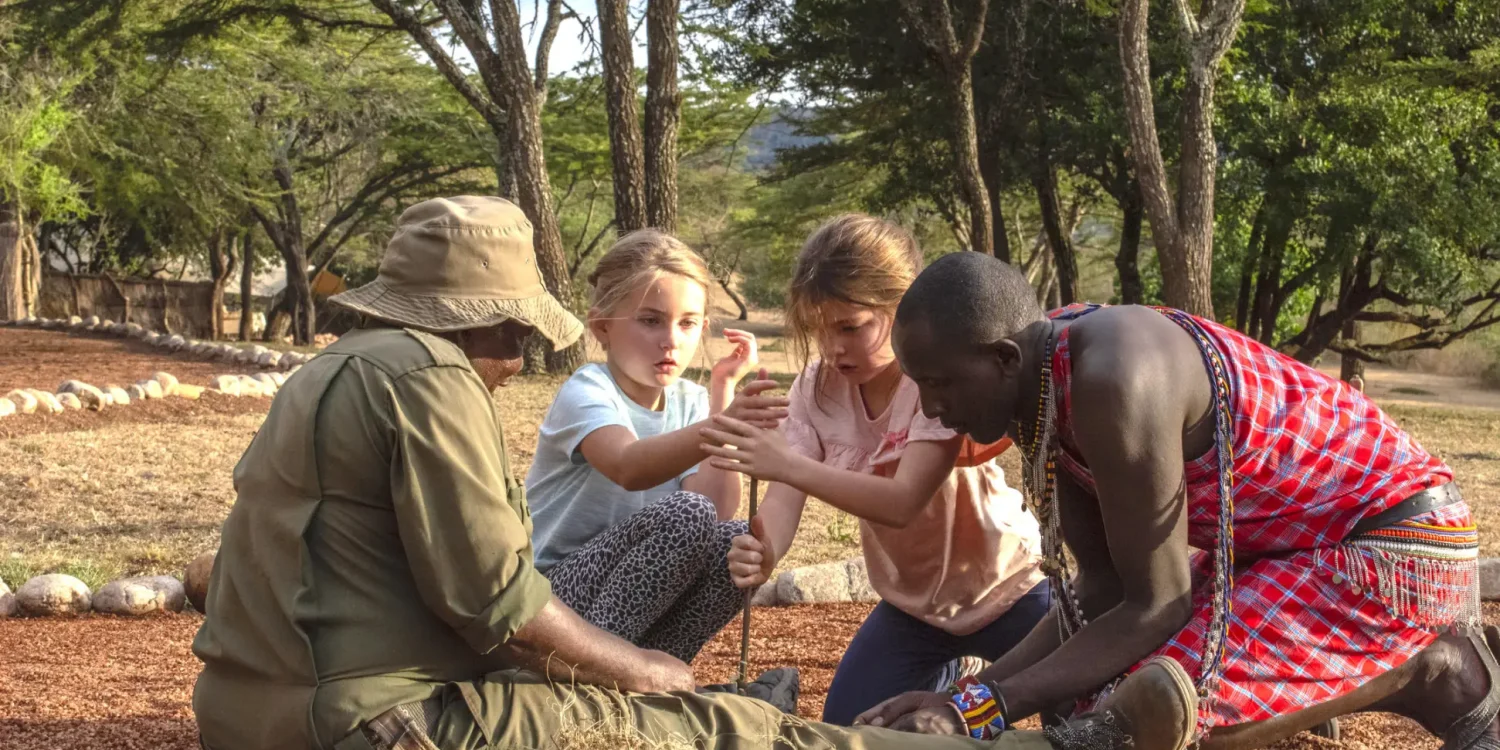 Family safari activity learning bush skills at Cottar’s 1920s Camp in the Maasai Mara experienced on a luxury family safari in Kenya