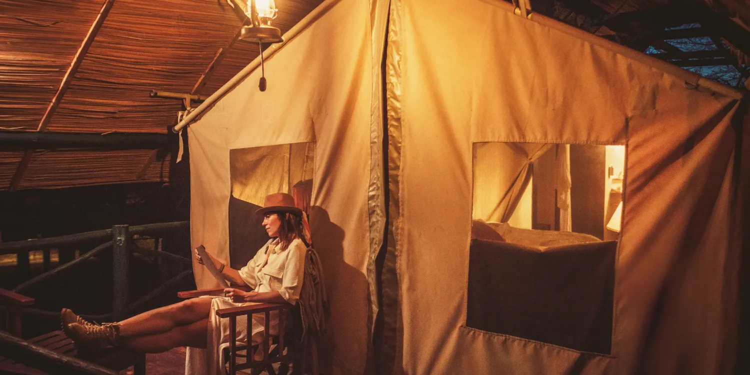 Solo traveler relaxing at a luxury safari camp in Africa