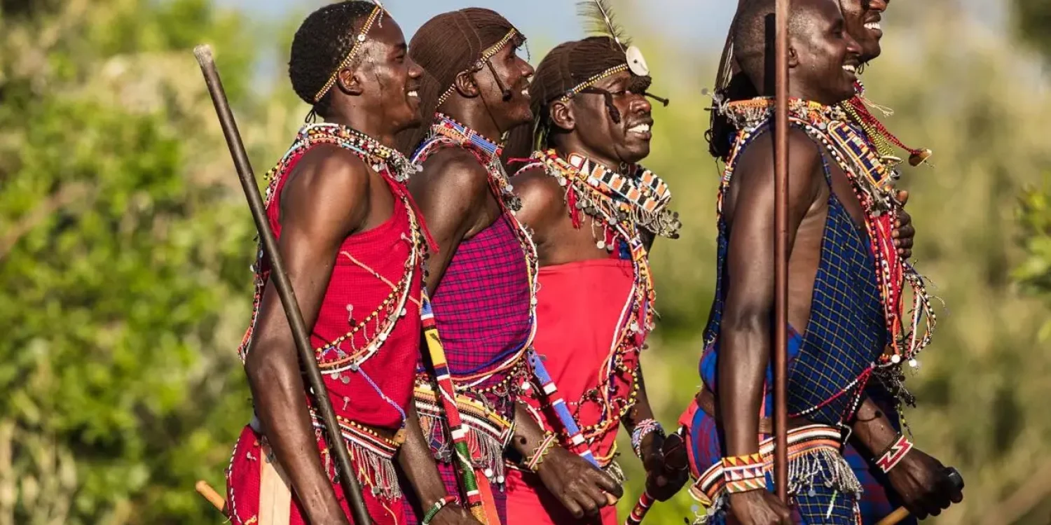 Maasai warriors in traditional attire showcasing culture during the best time to visit the Masai Mara