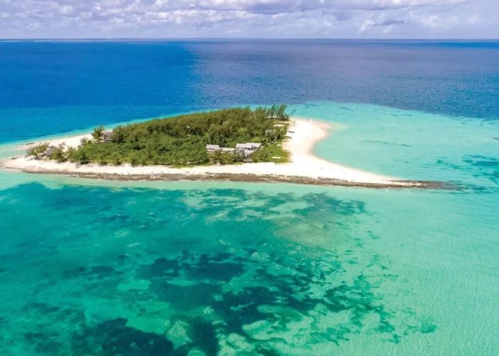 Aerial view of the pristine Thanda Island surrounded by turquoise waters and coral reefs off the coast of Tanzania.